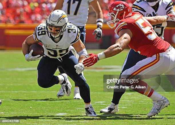 Running back Danny Woodhead of the San Diego Chargers rushes past linebacker Frank Zombo of the Kansas City Chiefs during the first half on September...