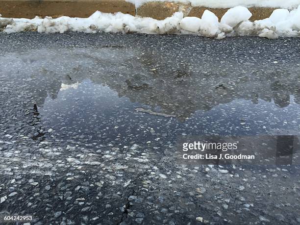 extreme weather - blizzard  - snow melting on sidewalk stock pictures, royalty-free photos & images