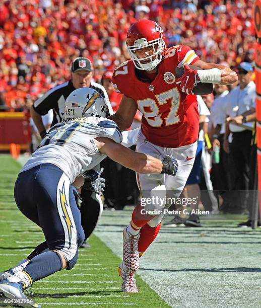 Tight end Travis Kelce of the Kansas City Chiefs makes a catch against linebacker Kyle Emanuel of the San Diego Chargers during overtime half on...