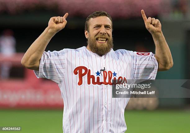 Wrestler Daniel Bryan reacts after throwing out the first pitch prior to the game between the Pittsburgh Pirates and Philadelphia Phillies at...