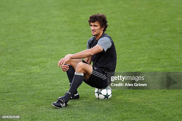 Roman Eremenko sits on a ball during a CSKA Moskva training session ahead of their UEFA Champions League Group E match against Bayer 04 Leverkusen at...
