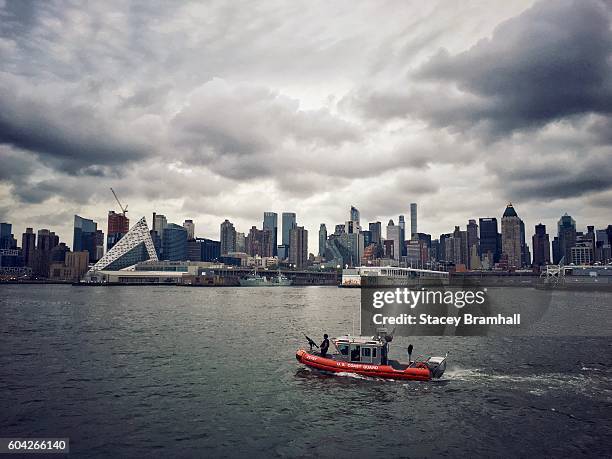 the coast guard patrols new york city's hudson river on a stormy day - guardacostas fotografías e imágenes de stock