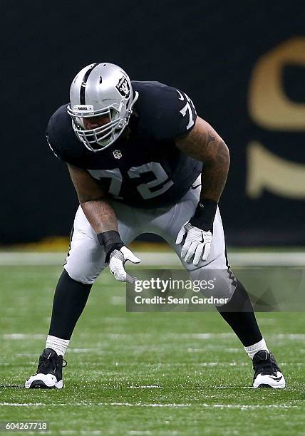 Donald Penn of the Oakland Raiders stands on the line of scrimmage during a game against the New Orleans Saints at the Mercedes-Benz Superdome on...