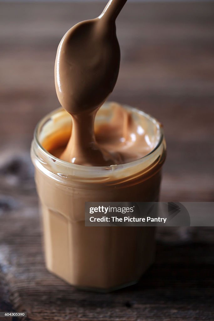 Natural homemade peanut butter in a glass jar