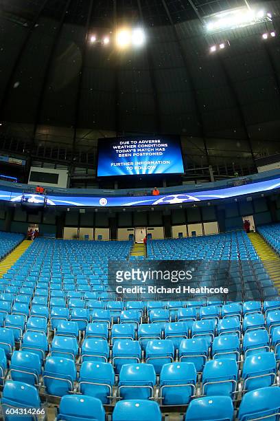 The big screen inside the stadium announces the postponement of the UEFA Champions League Group A match between Manchester City FC and VfL Borussia...