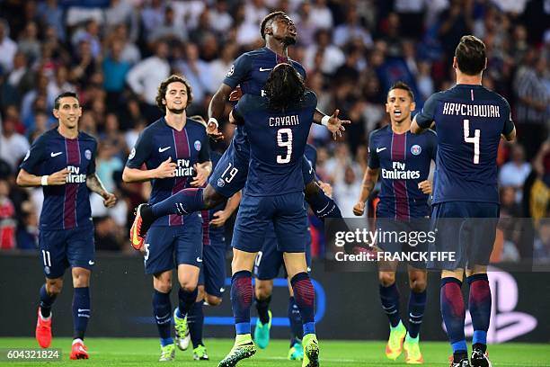 Paris Saint-Germain's Uruguayan forward Edinson Cavani celebrates after scoring with his teammate Paris Saint-Germain's Ivorian defender Serge Aurier...