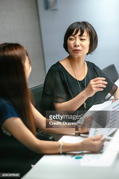 successful asian businesswomen preparing reports for board of directors - japan training session stock pictures, royalty-free photos & images