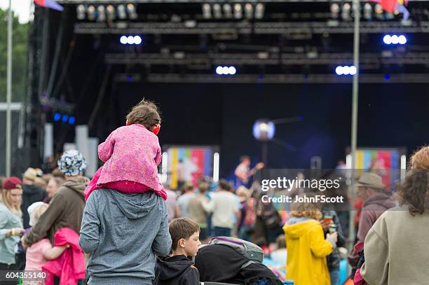 child wearing ear defenders at a scottish music festival - live event child stock pictures, royalty-free photos & images