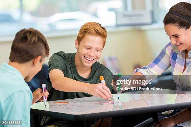 laughing teenagers working at makerspace on animation project - animated animation stock pictures, royalty-free photos & images