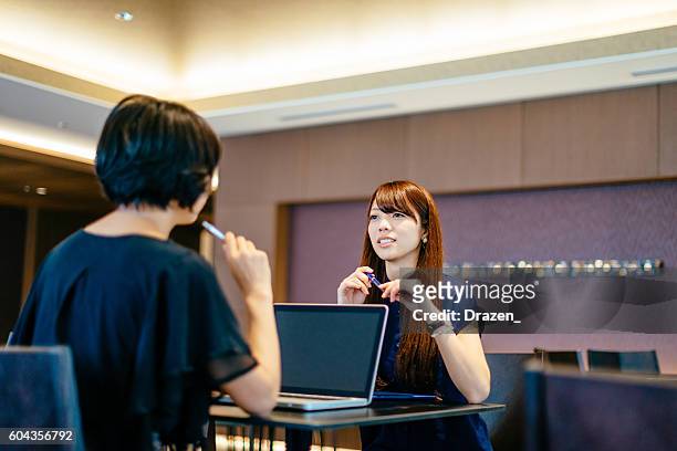 meeting of two successful japanese businesswomen - political meetings stock pictures, royalty-free photos & images