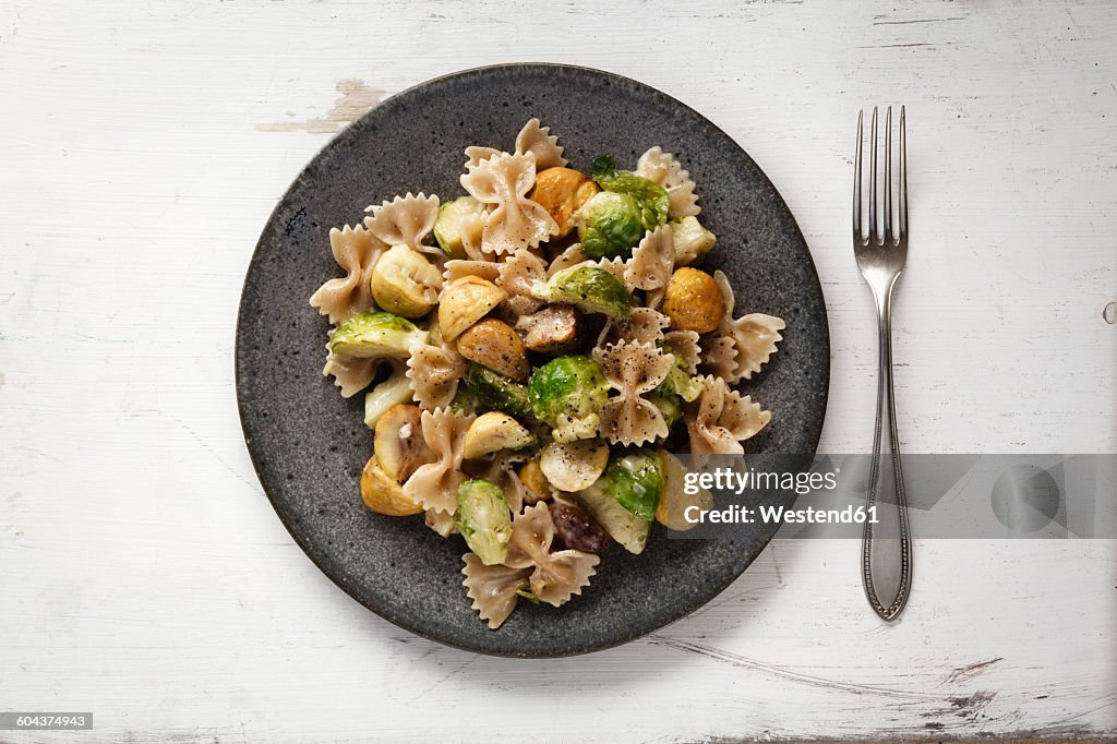 Dish of Brussels sprouts with sweet chestnuts and whole-grain noodles