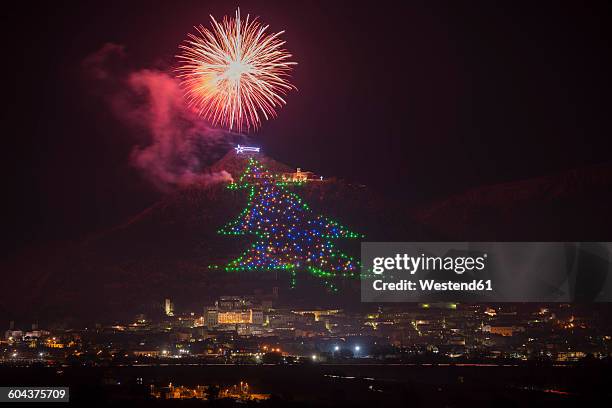 italy, umbria, province of perugia, gubbio, christmas tree on mount ingino, fireworks - gubbio stock pictures, royalty-free photos & images