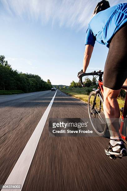 bike ride on a highway shoulder - calf human leg stock pictures, royalty-free photos & images