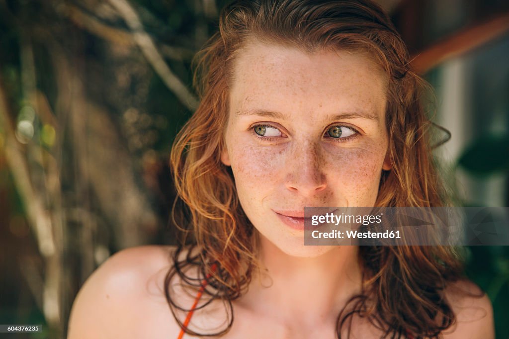 Brazil, Porto Seguro, portrait of curious woman with red hair and freckles