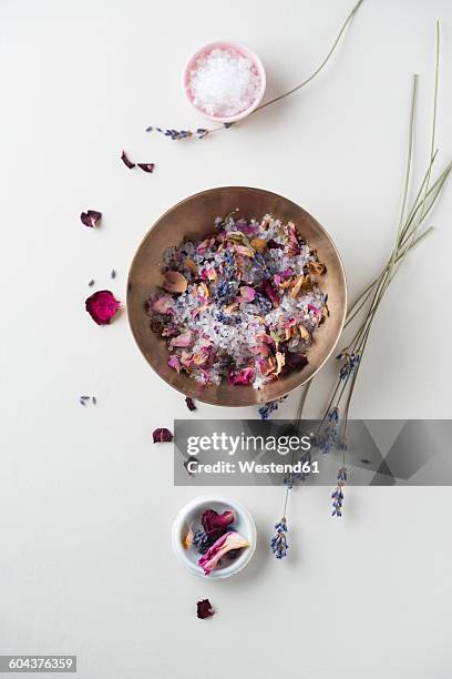 bowl of bath salts with dried rose petals and lavender blossoms - bath salt stock pictures, royalty-free photos & images