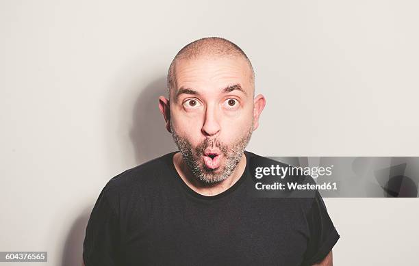 portrait of surprised man - shaved head ストックフォトと画像