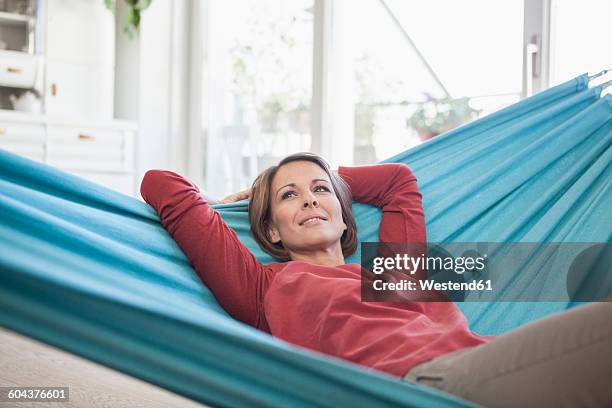 smiling woman at home lying in hammock - inside hammock stock pictures, royalty-free photos & images
