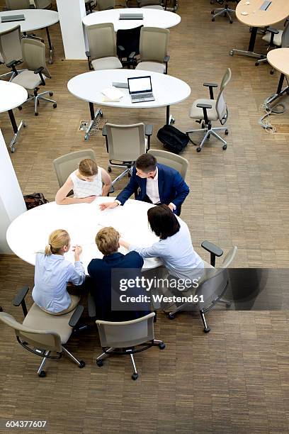 businesspeople having a meeting in office - round table discussion stock-fotos und bilder