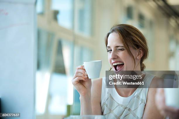 portrait of playful businesswoman winking - winking stock pictures, royalty-free photos & images