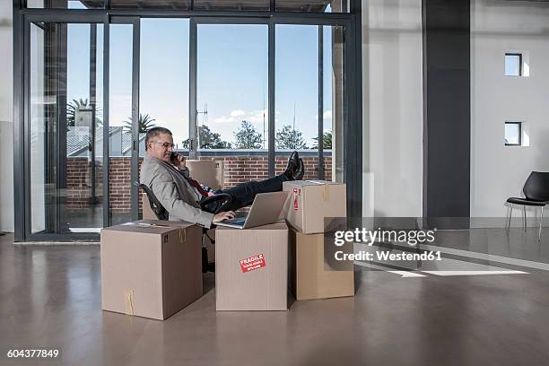 businessman using laptop in new office - moving office stock pictures, royalty-free photos & images