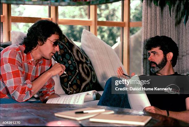 American filmmakers Steven Spielberg and George Lucas discuss an unspecified script in the offices of Amblin Entertainment on the Universal Studios...