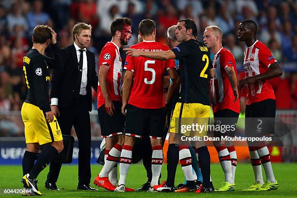 Players surround an injured Davy Propper of PSV Eindhoven during the UEFA Champions League Group D match between PSV Eindhoven and Club Atletico de...