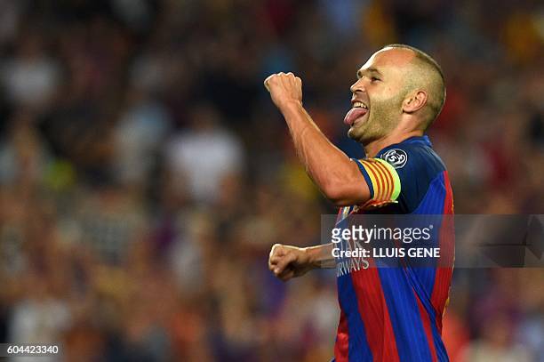 Barcelona's midfielder Andres Iniesta celebrates after scoring a goal during the UEFA Champions League football match FC Barcelona vs Celtic FC at...