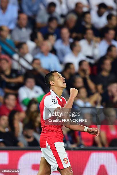 Arsenal's Chilean forward Alexis Sanchez celebrates after scoring during the UEFA Champions League Group A football match between Paris-Saint-Germain...