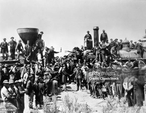 Group photo commemorating the ceremonial driving of the 'golden spike' to complete the First Transcontinental Railroad, at Promontory Point, Utah,...