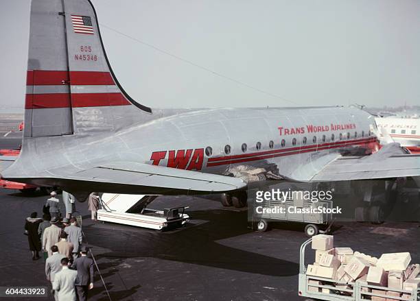 1950s ANONYMOUS PASSENGERS AND CARGO ON TARMAC BOARDING TRANS WORLD AIRLINES TWA PLANE LAGUARDIA AIRPORT NEW YORK USA