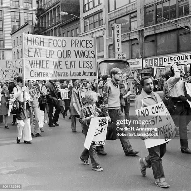 1970s PEOPLE IN DEMONSTRATION AGAINST HIGH FOOD PRICES CARRYING SIGNS BANNERS NEW YORK CITY USA