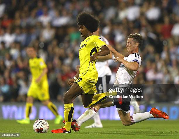 Scott Parker of Fulham tries to tackle Hamza Choudhury of Burton Albion during the Sky Bet Championship match between Fulham and Burton Albion at...