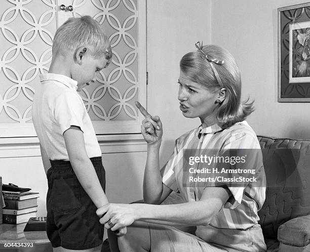 1970s MOTHER DISCIPLINING HER SON BY TALKING HARSHLY AND SHAKING HER FINGER BOY HANGING HIS HEAD IN SHAME