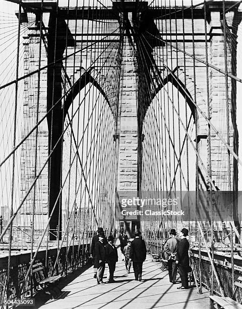 1800s 1880s MEN STANDING ON BROOKLYN BRIDGE JUST AFTER IT OPENED 1883 NEW YORK CITY USA