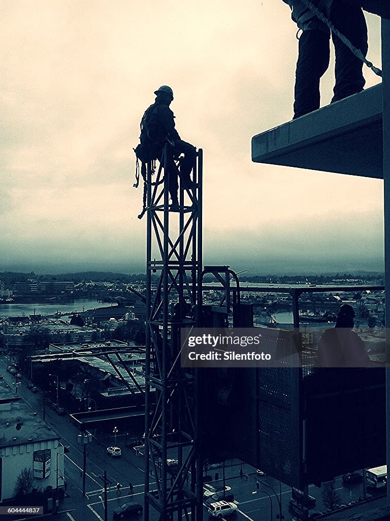 Construction Worker At Rest High Up In The Air