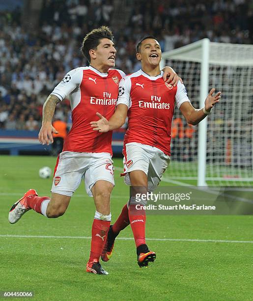 Alexis Sanchez celebrates scoring the Arsenal goal with Hector Bellerin during the UEFA Champions League match between Paris Saint-Germain and...