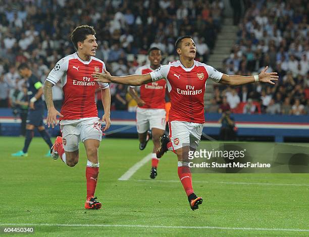 Alexis Sanchez celebrates scoring the Arsenal goal with Hector Bellerin during the UEFA Champions League match between Paris Saint-Germain and...