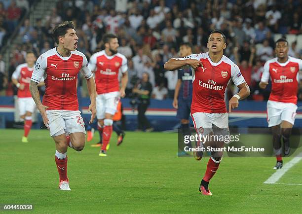 Alexis Sanchez celebrates scoring the Arsenal goal with Hector Bellerin during the UEFA Champions League match between Paris Saint-Germain and...