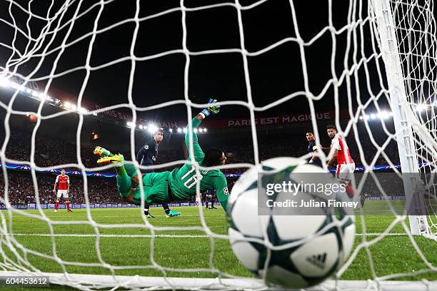 Alphonse Areola of PSG attempts to save as Alexis Sanchez of Arsenal scores his sides first goal during the UEFA Champions League Group A match...
