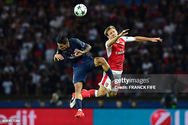 Paris Saint-Germain's Argentinian midfielder Angel Di Maria vies with Arsenal's Spanish defender Nacho Monreal during the UEFA Champions League Group...