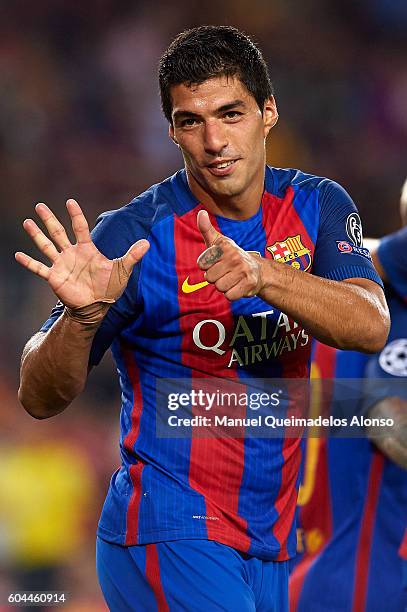 Luis Suarez of FC Barcelona celebrates scoring his team's seventh goal with his teammate Lionel Messi goal during the UEFA Champions League Group C...