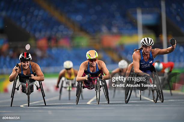 Chelsea McClammer, Amanda McGrory and Tatyana McFadden of the United States celebrate winning the silver, bronze and gold medals respectively in the...