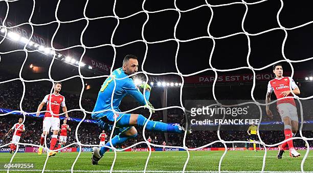 Arsenal's Colombian goalkeeper David Ospina tries to catch the ball during the UEFA Champions League Group A football match between...