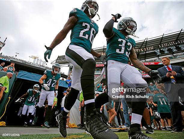 Jaylen Watkins and Ron Brooks of the Philadelphia Eagles take the field for warmups before a game against the Cleveland Browns at Lincoln Financial...