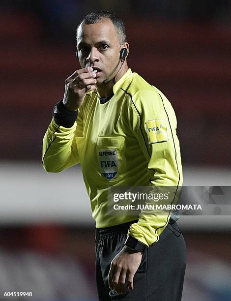 Brazilian referee Wilton Sampaio gestures during the Copa Sudamericana football match between Argentine football teams San Lorenzo and Banfield at...