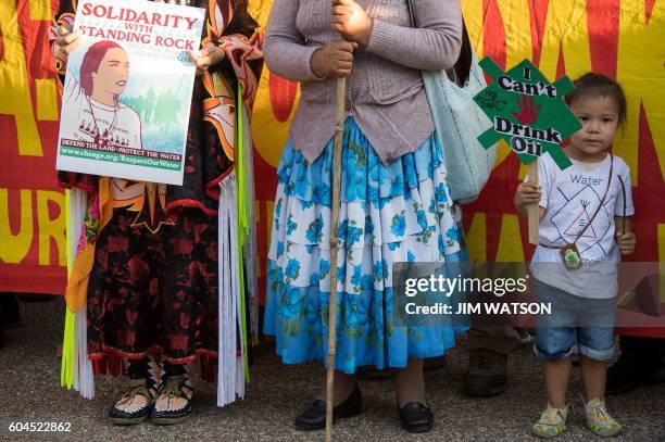 Young girl holds a small placard reading "I Can't Drink Oil" as she stands with demonstrators that gathered in front of the White House in...