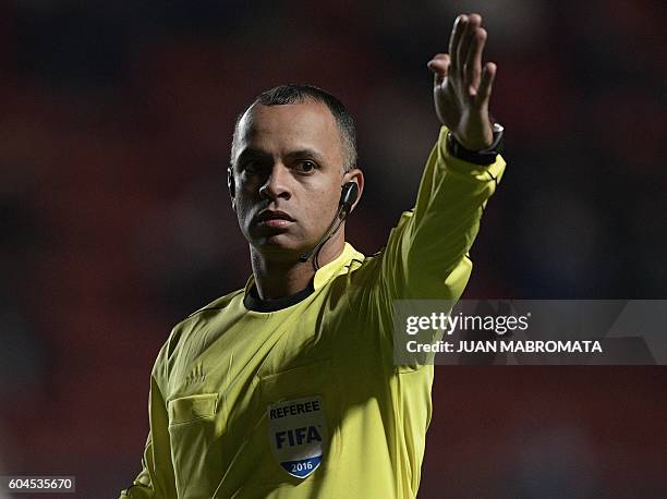 Brazilian referee Wilton Sampaio gestures during the Copa Sudamericana football match between Argentine football teams San Lorenzo and Banfield at...