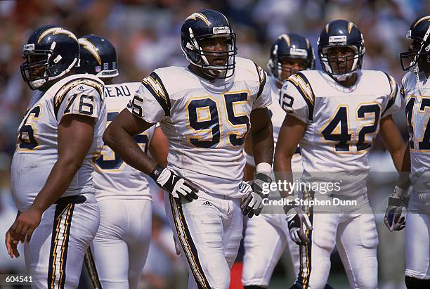 Al Fontenot, Rogers Beckett, and Jamal Williams of the San Diego Chargers break from the huddle and start to line up during the Pre-Season game...