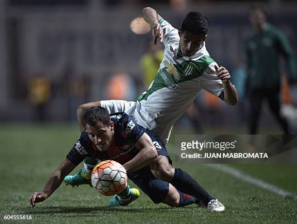 Argentina's San Lorenzo midfielder Sebastian Blanco vies for the ball with Argentina's Banfield defender Alexis Soto during their Copa Sudamericana...