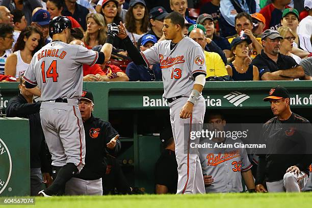 Nolan Reimold of the Baltimore Orioles returns to the dugout after hitting a two-run home run in the second inning of a game against the Boston Red...